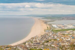 View from the South West Coast Path with clouds over Weymouth in the background